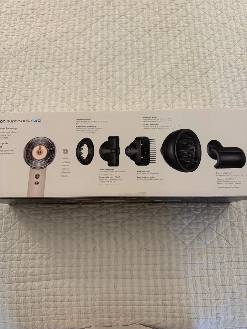 Dyson hair dryer kit in white with copper accent and black attachments